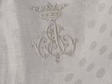 embroidered monograms on a bed sheet with a crown on top