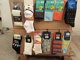 several pairs of socks are stacked on a pallet in front of a wall
