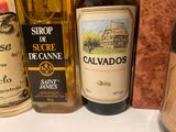 several bottles of wine are lined up on a counter top