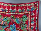an image of a red cloth with a peacock design on it