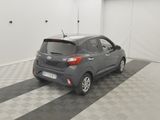 a grey car parked in a garage with a checkered floor