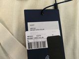 the back of a white sweater with a tag on it