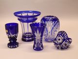 a lot of blue glass items sitting on a table