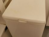 a white washer and dryer in a small room