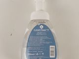 clear foam hand sanitizer in a clear bottle on a white surface