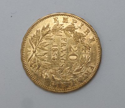 a close up of a gold coin on a white surface