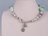the necklace is made of glass beads and a silver charm