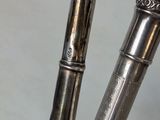 a silver pen that is sitting on top of a blue table
