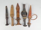 five different types of knifes on a white surface