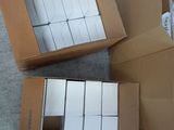 two boxes of white boxes sitting on the ground