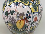 a vase with a picture of fruit and flowers on it