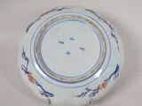a white plate with blue and orange designs on it