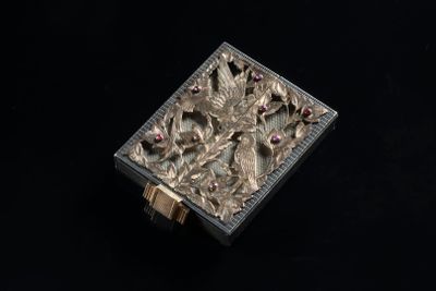 an image of a silver box with flowers and leaves on it