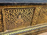 a black and gold chest sitting on top of a wooden floor
