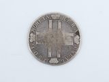 a close up of a silver coin with a cross on it