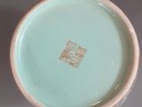 a small bowl with a gold design on it
