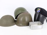 a helmet, a hat, and a tin on a white surface