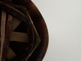 a close up of a brown hat with a leather band