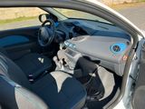 the interior of a car with the door open and a steering wheel