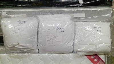 a pile of mattresses that are in a box