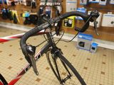 a bike that is sitting in a store with a red handlebar