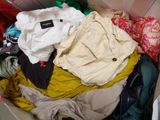 a box full of clothes that is sitting on the floor