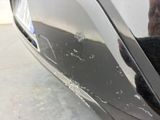 a black cat that is sitting on the side of a car