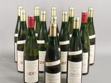 six bottles of wine are lined up in a row on a table
