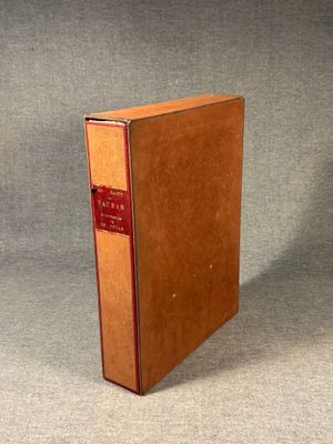 an old book sitting on top of a table on a gray surface