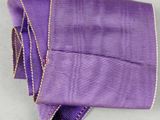 purple ribbon with a gold star on it and a purple ribbon with a gold star on it