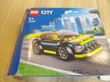 a box of lego city cars on a table