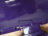 a close up of a purple laptop computer on a table