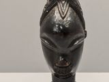 a statue of a woman sitting on top of a vase