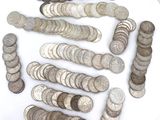 a lot of coins on a white plate on a table