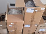 many cardboard boxes stacked on top of each other on the floor