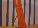a red book sitting on a metal stand on a table