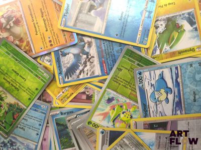 a pile of pokemon cards sitting on top of a table