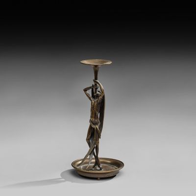 an image of a bronze statue of a woman holding a bowl