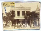 an old photo of a group of people standing outside of a building