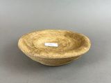 small bowl with a label on it sitting on a gray surface