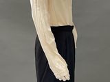 an image of a mannequin wearing a white blouse and black skirt