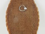 a brown crochet with a silver ring on top of it