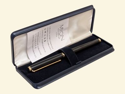 a black pen in a black case with a note in it