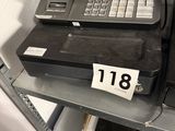 a cash register on a shelf in a store