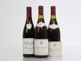 three bottles of wine are lined up on a table