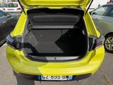 a yellow car with its trunk open in a parking lot