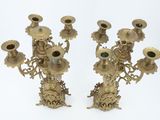 pair of antique brass candelabs with flowers on each of them