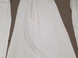 three pieces of white towels laid out on the floor next to a chair
