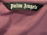 the label on the back of a pink jacket that says palm angels
