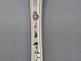 a spoon that has a spoon with a picture on it